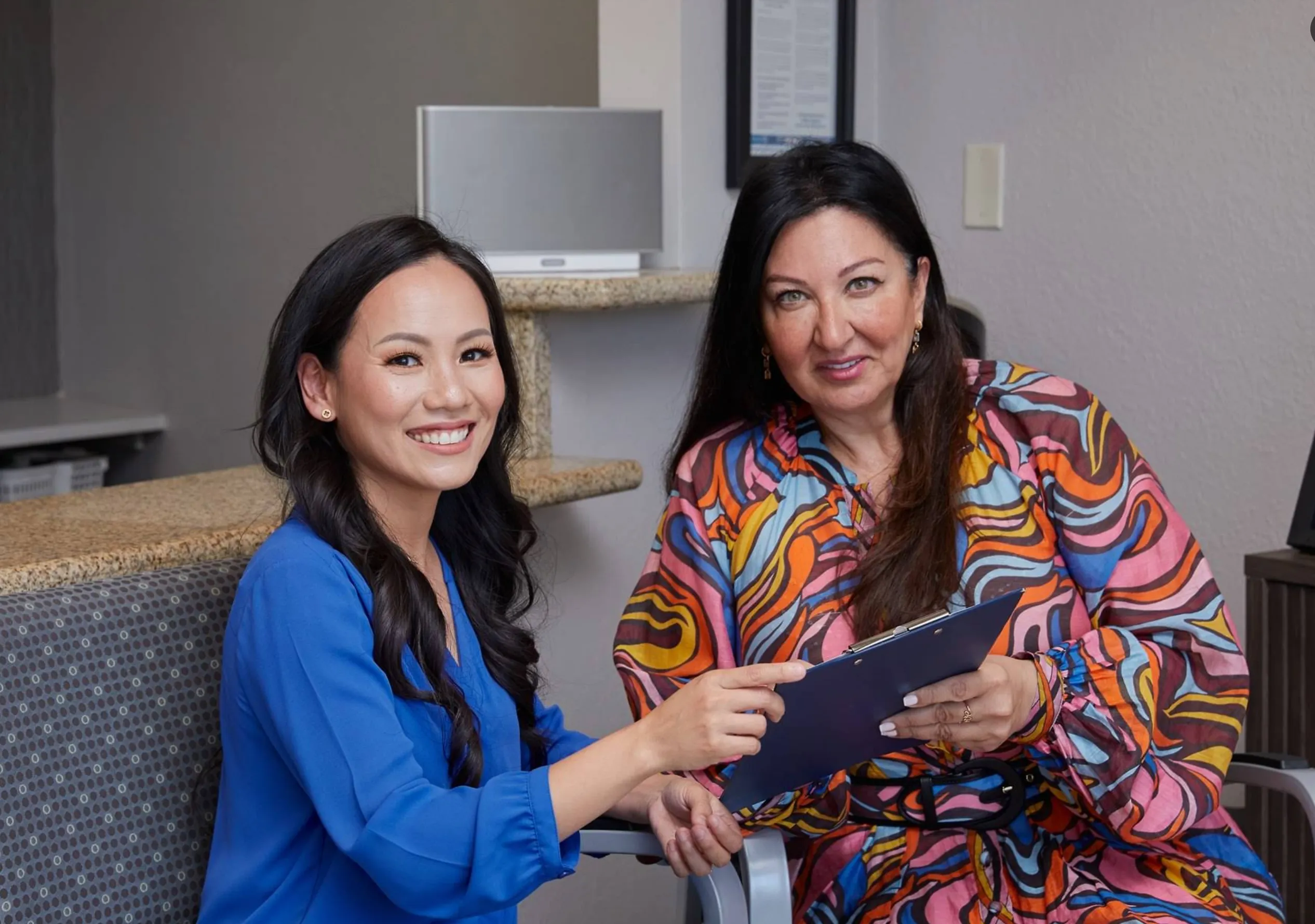 A+ Family Dentistry team member reviewing care with a patient